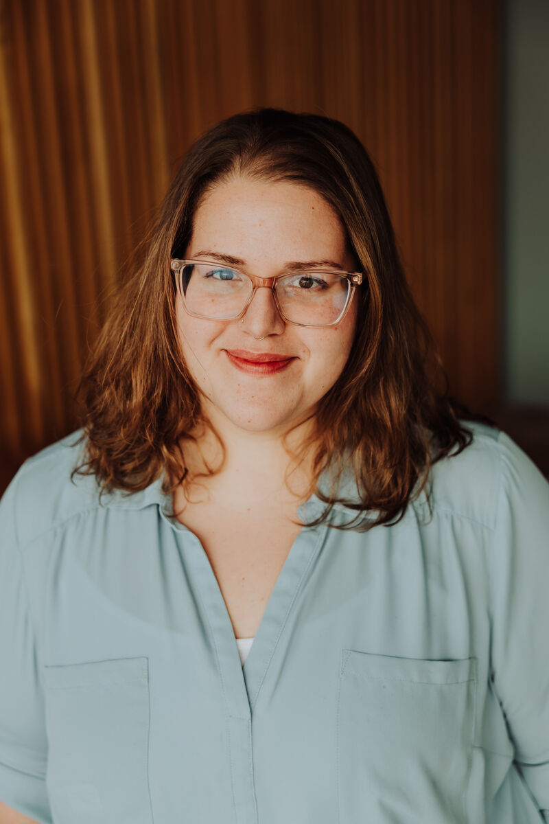 Headshot of Jenn with a soft smile